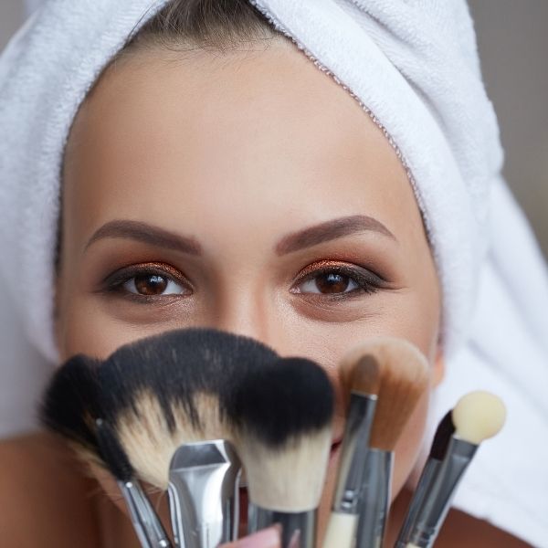 woman with makeup brushes