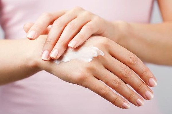woman uses hand cream